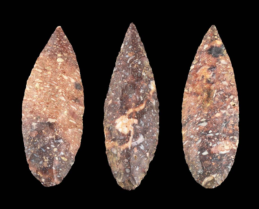 Lot of 3 Colima Chert Blades: Pre-Columbian, West Mexico, Colima, ca. 300 BCE to 300 CE. A fine trio of knapped chert blades with petaloid profiles and sharp edges. The stones are a lovely chert with red and mauve hues and mottled