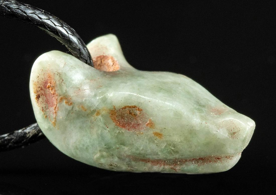 Mixtec Greenstone Canid Amulet on Cord: Pre-Columbian, Valley of Mexico, Oaxaca, Mixtec people, ca. 900 to 1200 CE. A fabulous hand-carved greenstone amulet pendant of a canid head. The triangular head points downward with the snout, slight