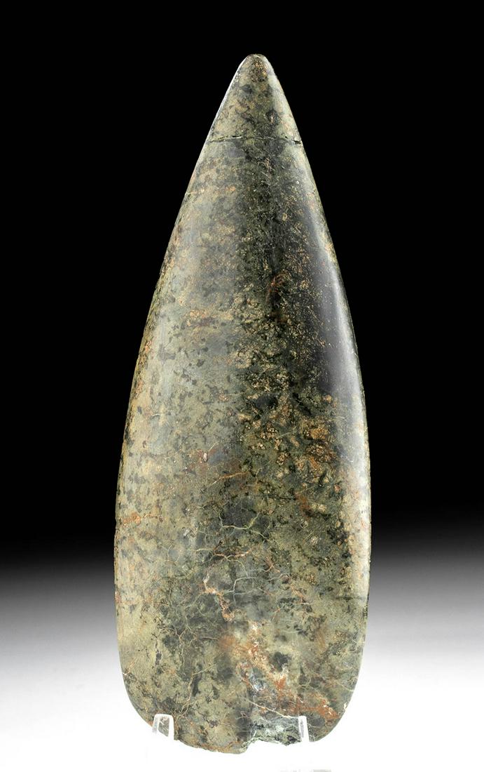 Taino Greenstone Petaloid Celt: Pre-Columbian, Dominican Republic, Taino / Ciboney peoples, ca. 1000 to 1500 CE. A beautiful celt or axe blade, hand carved and polished from a greenstone. The petaloid shape has a slender handle with