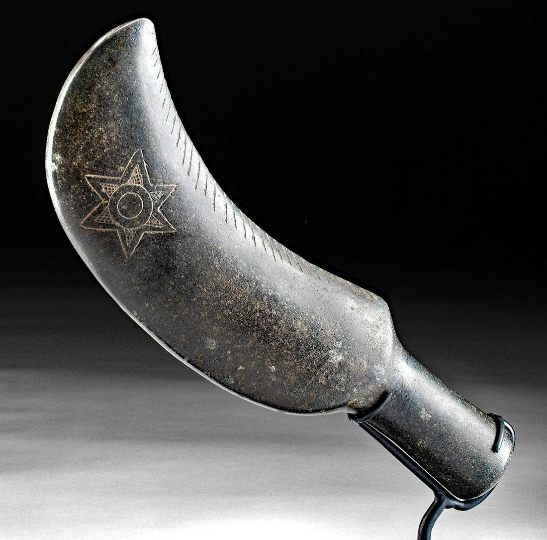 Mapuche Stone Clava w/ Incised Inca Star: Pre-Columbian, Chile, Mapuche, Inca Period, ca. 1200 to 1500 CE. A very rare type of Mapuche clava with a curved crescent-moon shaped blade and a tubular handle, finely carved from an attractive black