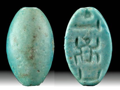 Egyptian Faience Bead Cartouche Thutmose I, ex-Mitry: Ancient Egypt, New Kingdom, 18th Dynasty, reign of Thutmose I, ca. 1503 to 1493 BCE. A petite bead of a characteristic ovoid form with a suspension hole perforated lengthwise through the body. The