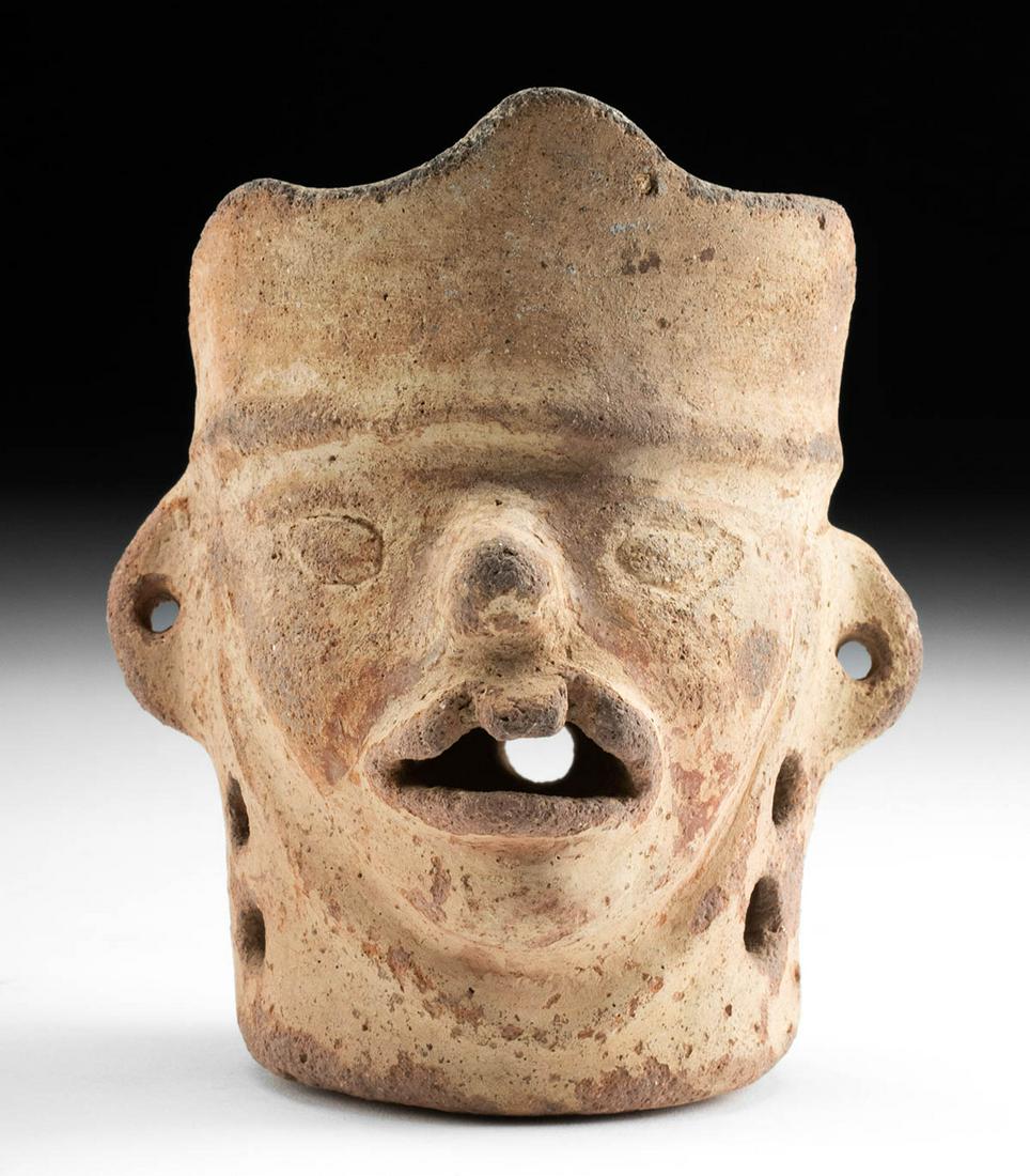 Moche Pottery Rattle - Man with Harelip: Pre-Columbian, North Coast Peru, Moche, ca. 200 to 600 CE. An intriguing handmade pottery rattle of cylindrical form, still functional, and sculpted in the form of a man's head. With an undulating cro
