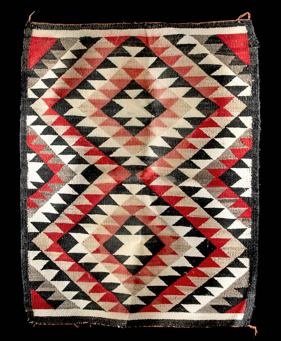Navajo Woven Wool Saddle Blanket - Ca. 1920: Native American, Navajo Nation, Arizona, ca. 1920 CE. Woven wool saddle blanket in a variant of an Old Style Crystal Eye Dazzler Pattern. In bold pattern of jagged double-diamonds in colors of red, wh