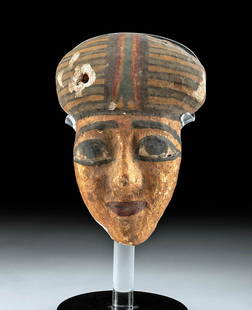 Egyptian Late Dynastic Polychrome Wood Mask: Egypt, Late Dynastic Period, ca. 664 to 332 BCE. A dramatic wooden sarcophagus mask of an engaging visage with boldly lined almond-shaped eyes, thick brows, a straight noble nose, a full-lipped