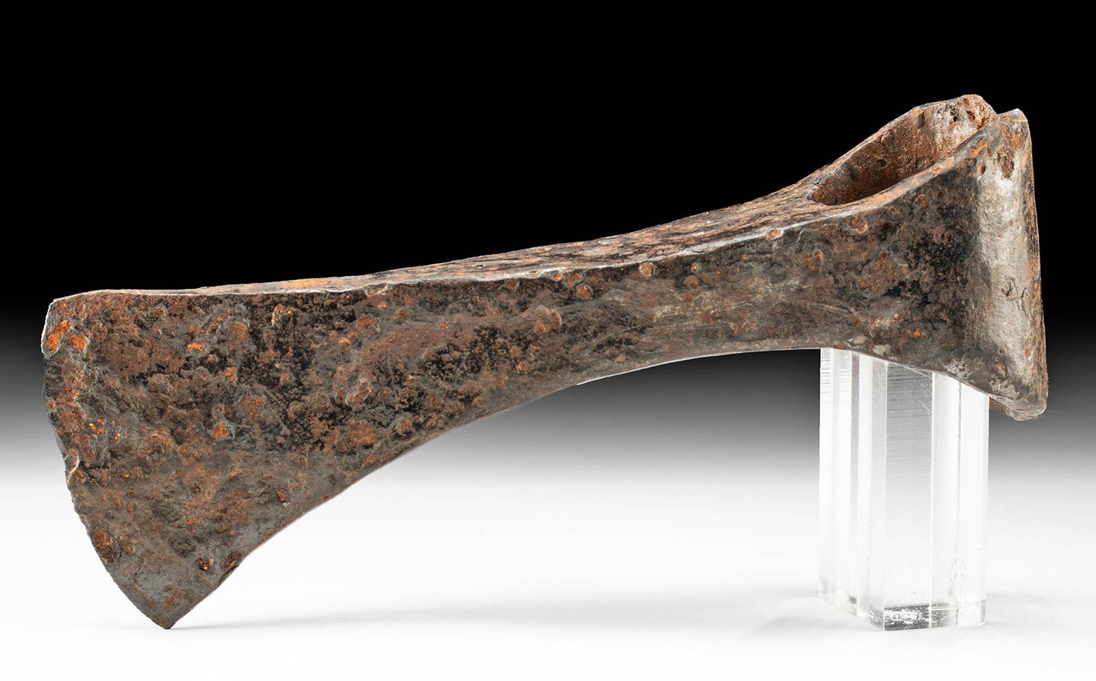 Viking Iron Socketed Axe Head: **Originally Listed At $300** Northern Europe, Scandinavia, Viking or Norse culture, ca. 8th to 10th century CE. A forged-iron axe head of a sizable form with a lengthy neck, a vertical blade with fla