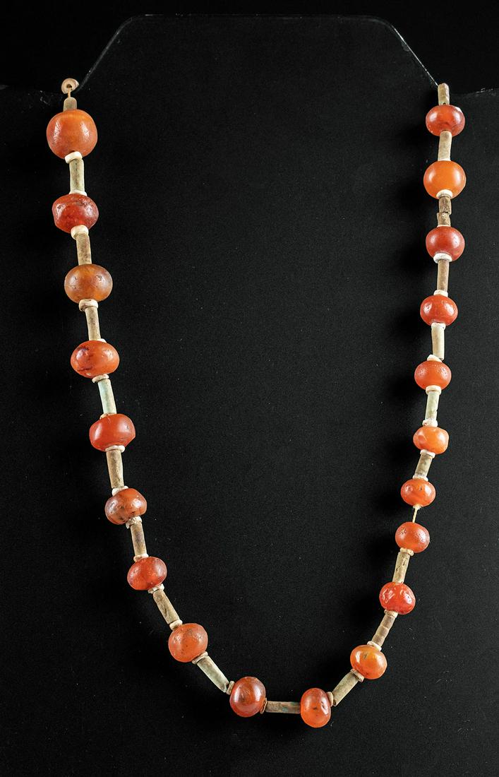 Egyptian Carnelian / Faience Bead Necklace: **First Time At Auction** Ancient Egypt, Late Dynastic period, ca. 712 to 332 BCE. A dazzling set of 25 spherical carnelian beads of a translucent, cinnabar red beautifully arranged in a repetitive pa
