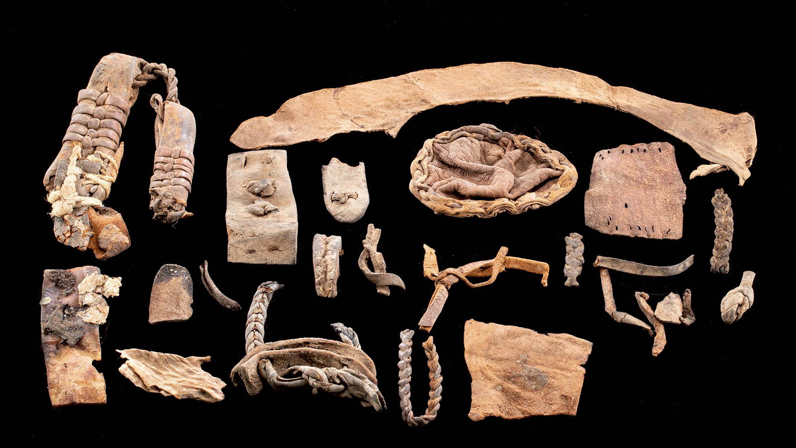 Lot of 19 Egyptian Leather Fragments: **First Time At Auction** Egypt, Late Dynastic to Romano-Egyptian Period, ca. 664 BCE to 2nd century CE. A gathering of 19 fragmentary leather pieces from ancient Egypt that were perhaps used as cloth