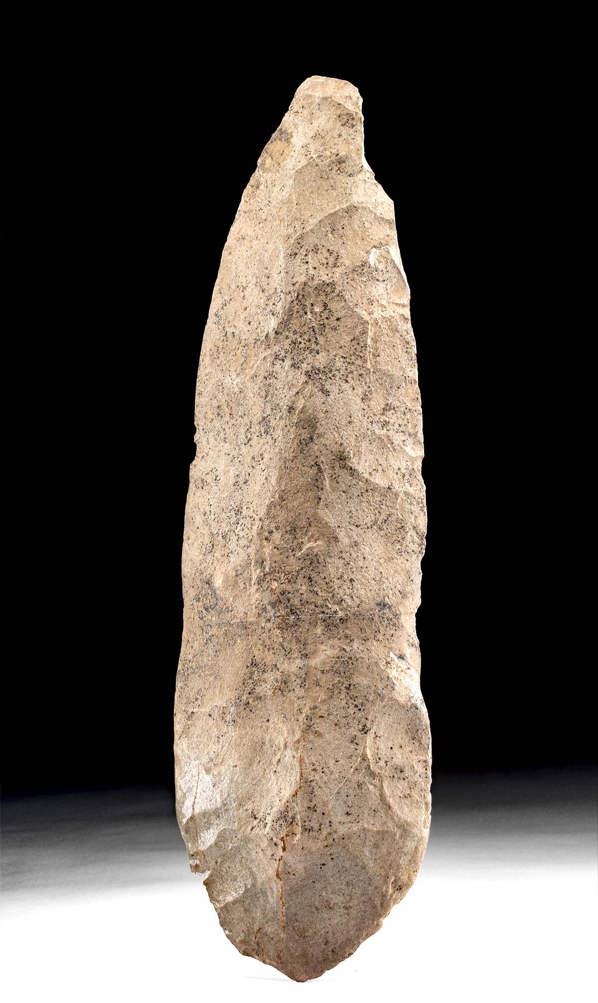 Huge Native American Knapped Stone Hoe / Spade: **First Time At Auction** North America, Southeastern/midwestern United States, ca. 1000 to 1500 CE. A very large knapped stone hoe or spade of beige and grey hues, with a rounded butt and two convex