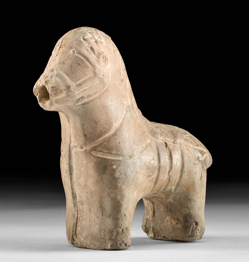 Roman Judaea Pottery Horse Figurine: Roman Judaea, Imperial Period, ca. 100 CE. A lovely, mold-made pottery equine figure, standing upon its legs and presenting a proud form that is nicely detailed with incised bridle and reins. Horses s