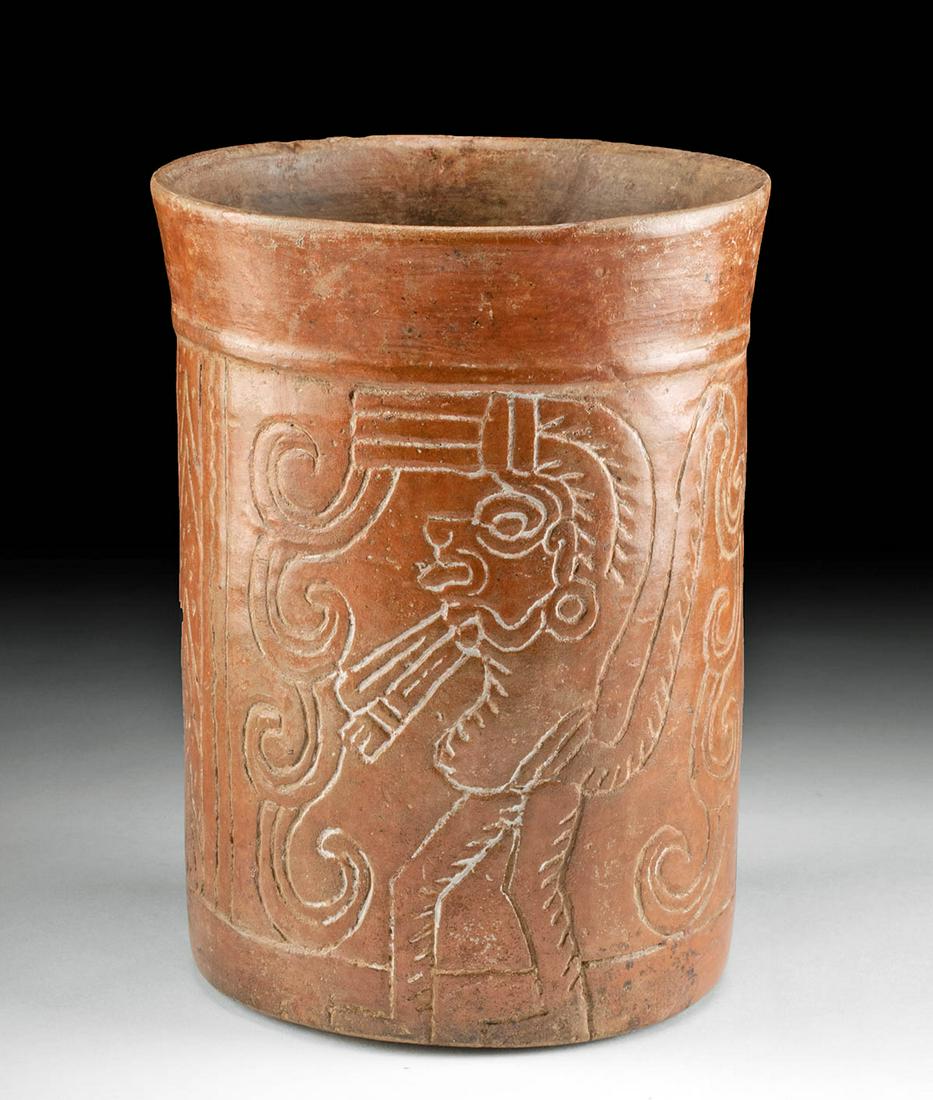 Maya Incised Pottery Cylinder - Monkey God: Pre-Columbian, Maya territories, ca. 550 to 900 CE. A redware cylinder, finely incised with two depictions of the monkey god , one on each side, standing in profile, likely processing forward as one l