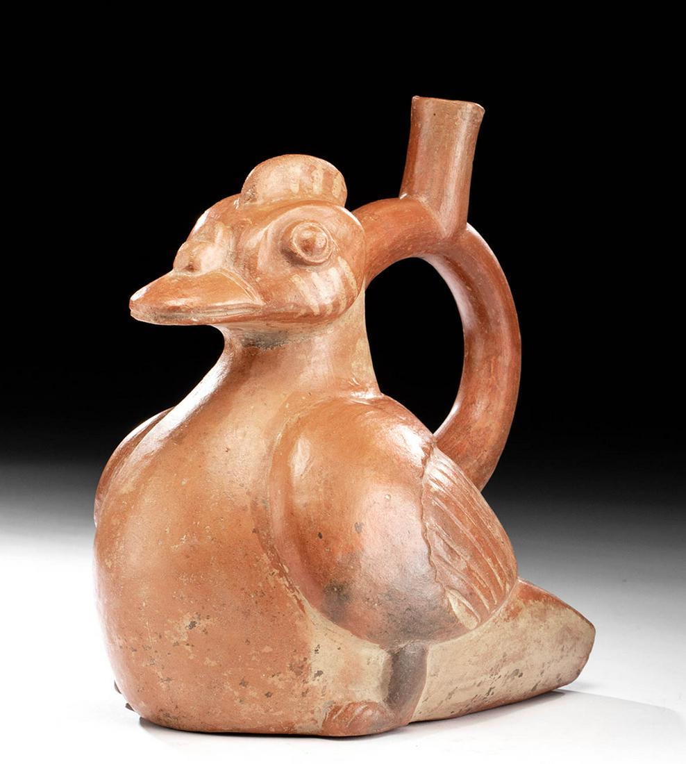 Moche Redware Stirrup Vessel Muscovy Duck: Pre-Columbian, Peru (North Coast), Moche III, ca. 300 CE. A mold-made bi-chrome ceramic vessel in the form of a seated Muscovy duck, its body fat, its head proudly forward above its chest. A stirrup h