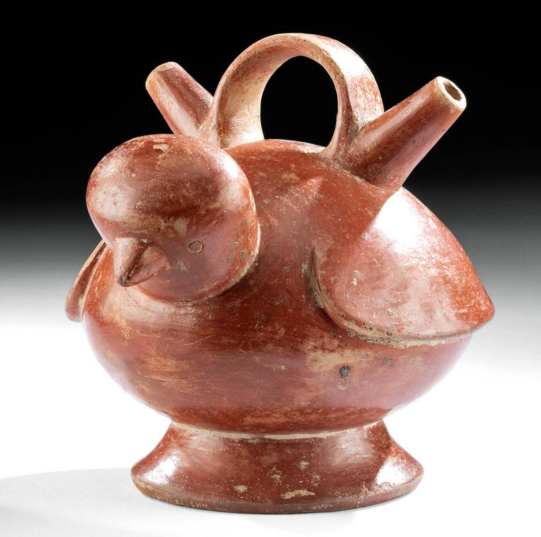 Calima Redware Twin-Spouted Alcarraza - Bird Form: Pre-Columbian, Colombia, Valle Del Cauca, Calima culture, Yotoco phase, ca. 300 to 1300 CE. A hand-built pottery alcarraza vessel in the shape of a plump bird with folded wings, a plump body, and a pe