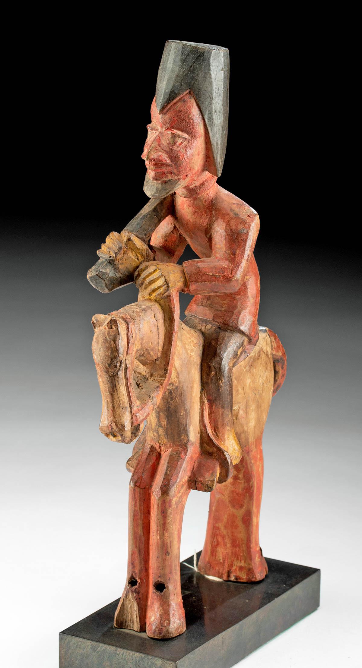 Yoruba Wooden Equestrian Figure: West Africa, Benin and Nigeria, Yorubaland, Yoruba peoples, ca. late 19th to early 20th century CE. A handsome hand-carved wooden sculpture of a horse and rider painted in hues of ochre, chocolate bro