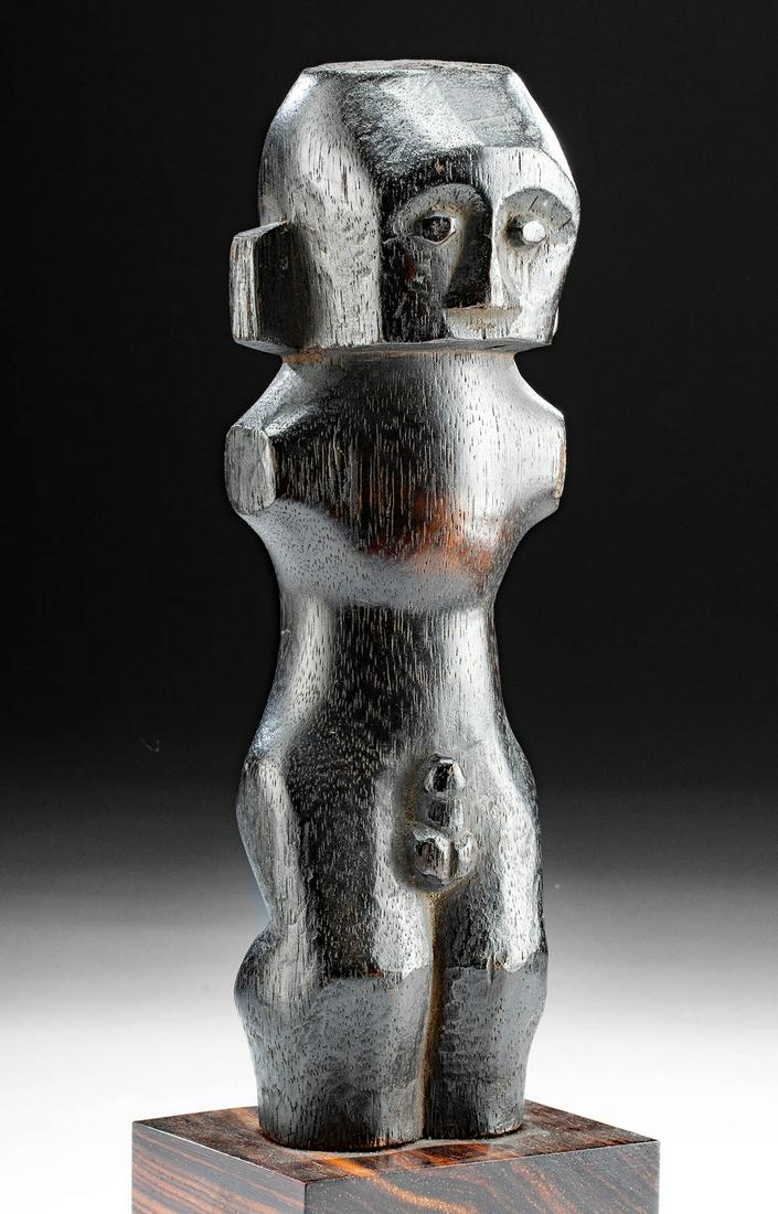 Mid 20th C. Nias Wood Standing Male Figure: Indonesia, Nias island off west coast of North Sumatra, Nias culture, ca. mid 20th century. An elegant carved-wood figure of a crouching nude male shown from the calves/knees up. The minimalistic figu