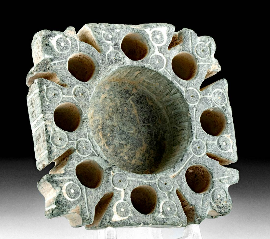 Bactrian Schist Cosmetic Dish: Ancient Central Asia, Bactria, ca. 2500 to 2250 BCE. A beautifully preserved cosmetic dish carved from schist of a sage-green hue. The broad dish bears 8 petite receptacles within the floral-form arms