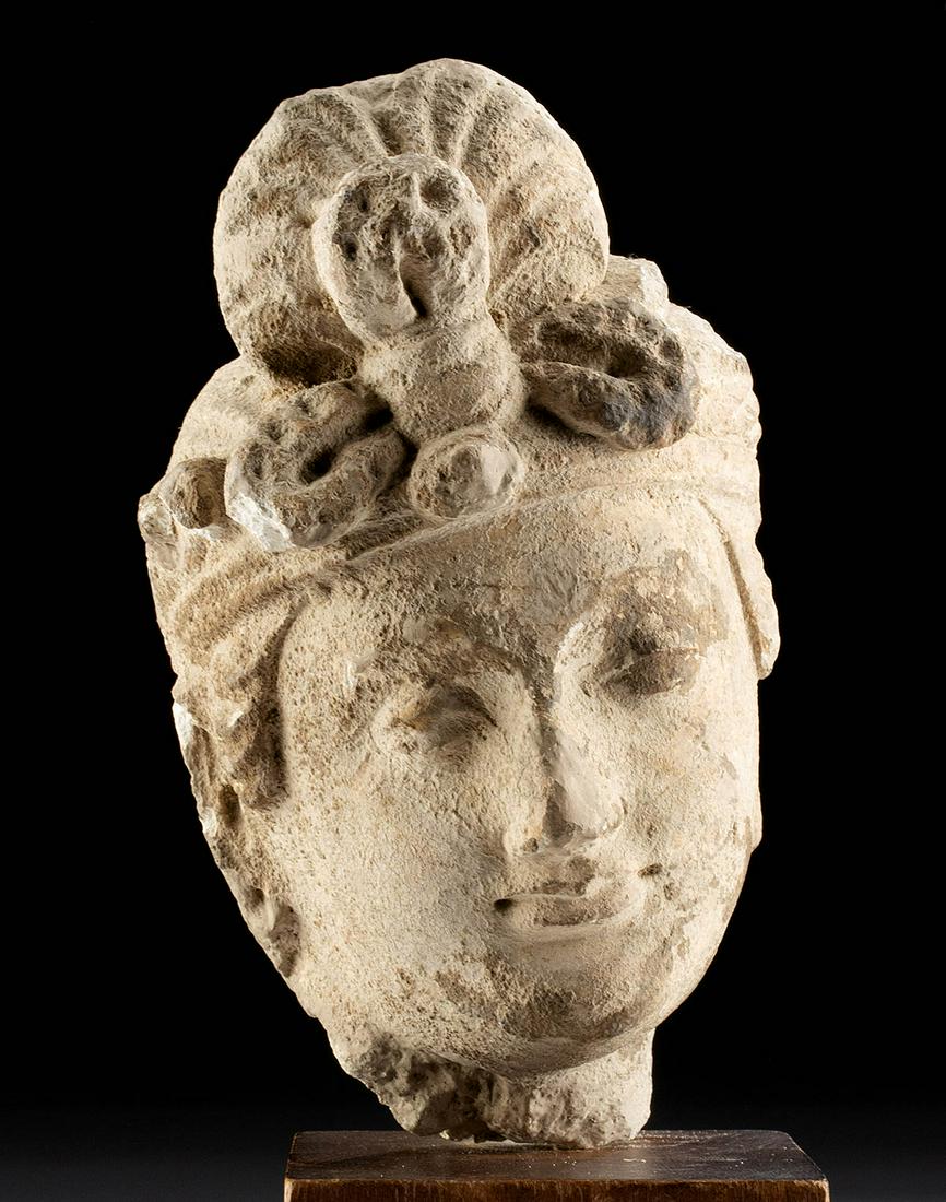 Gandharan Stucco Head of Prince: Central Asia, Pakistan and Afghanistan, Gandharan Empire, ca. 3rd to mid 5th century CE. An elegant stucco head of a prince or bodhisattva, modeled in the traditional Greco-Buddhist tradition with a f