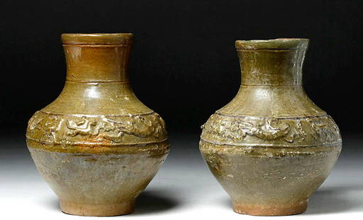 Chinese Han Dynasty Glazed Hu Vases Matched Pair: East Asia, China, Han Dynasty, ca. 206 BCE to 220 CE. A rare matched pair of Eastern Han Dynasty classical ceramic Hu vessels - their elegant forms of a baluster shape with slightly flaring necks and