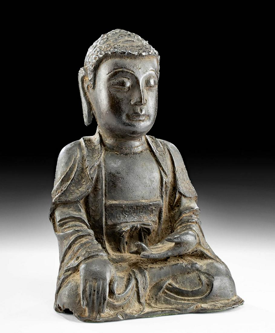 14th C. Korean Joseon Bronze Shakyamuni Buddha: East Asia, Korea, Joseon period, ca. 14th to 16th century CE. A hollow cast leaded bronze Buddha (Shakyamuni, the Enlightened form), dressed in traditional robes with an elegant sash tied in a bow aro