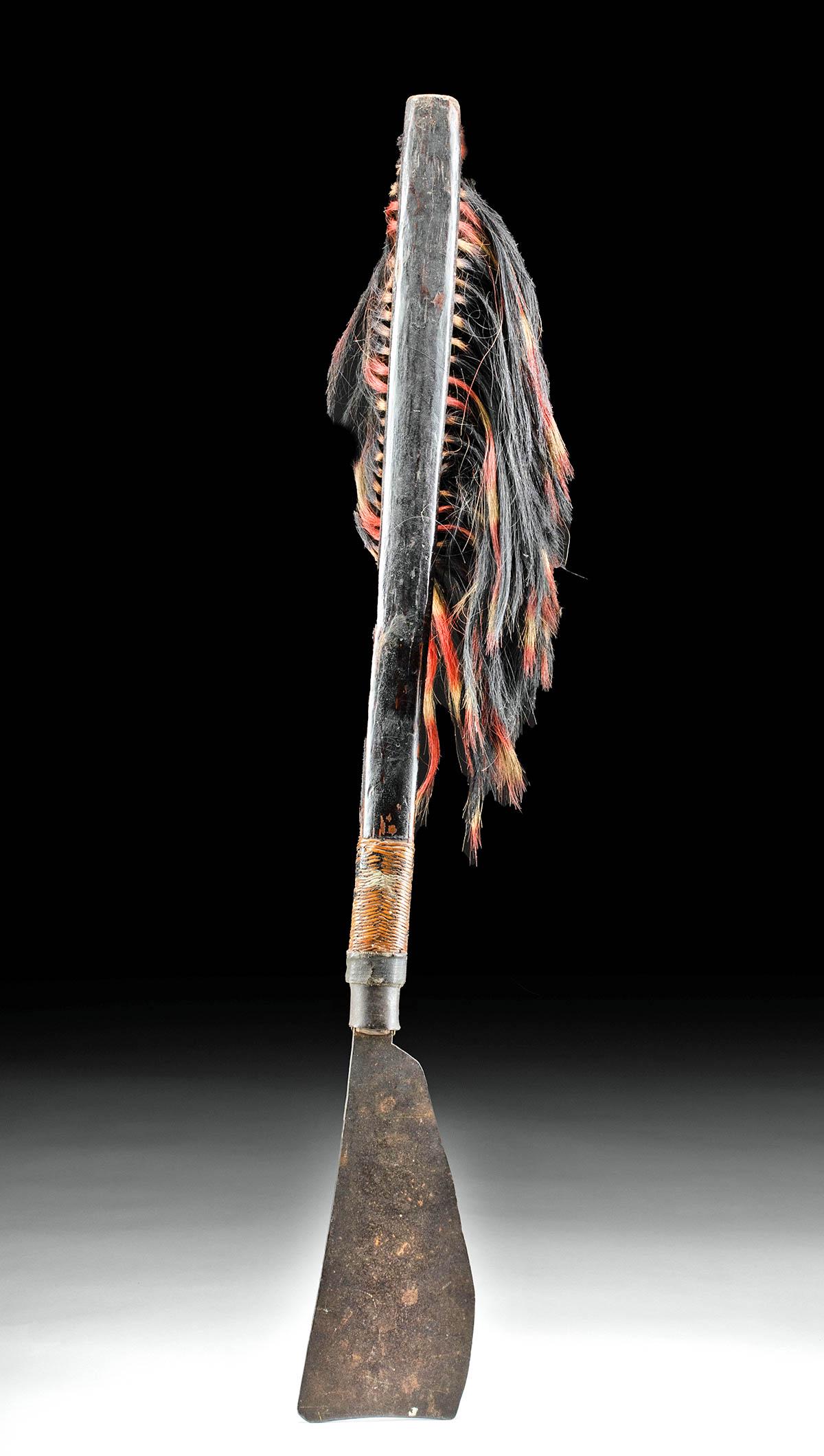 19th C. Indian Naga Wood & Iron Sema Dao w/ Hair Tassel: South Asia/Southeast Asia, India/Burma (present day Myanmar) border, Nagaland, Sumi Naga people, ca. late 19th to early 20th century CE. An intimidating axe known as a sema dao comprised of a large st