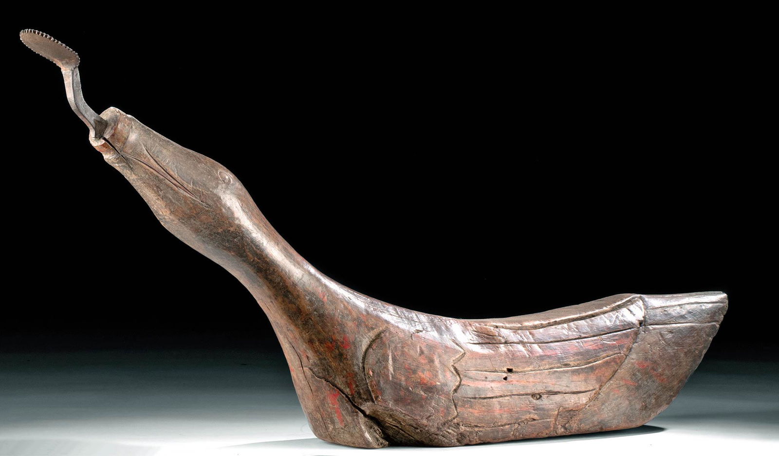 19th C. Thai Wood / Iron Coconut Grater - Bird: Southeast Asia, Thailand, late 19th to early 20th century CE. A hand-carved wooden coconut grater depicting a bird - likely a duck, swan, goose, or other waterfowl - rendered with its neck arched and