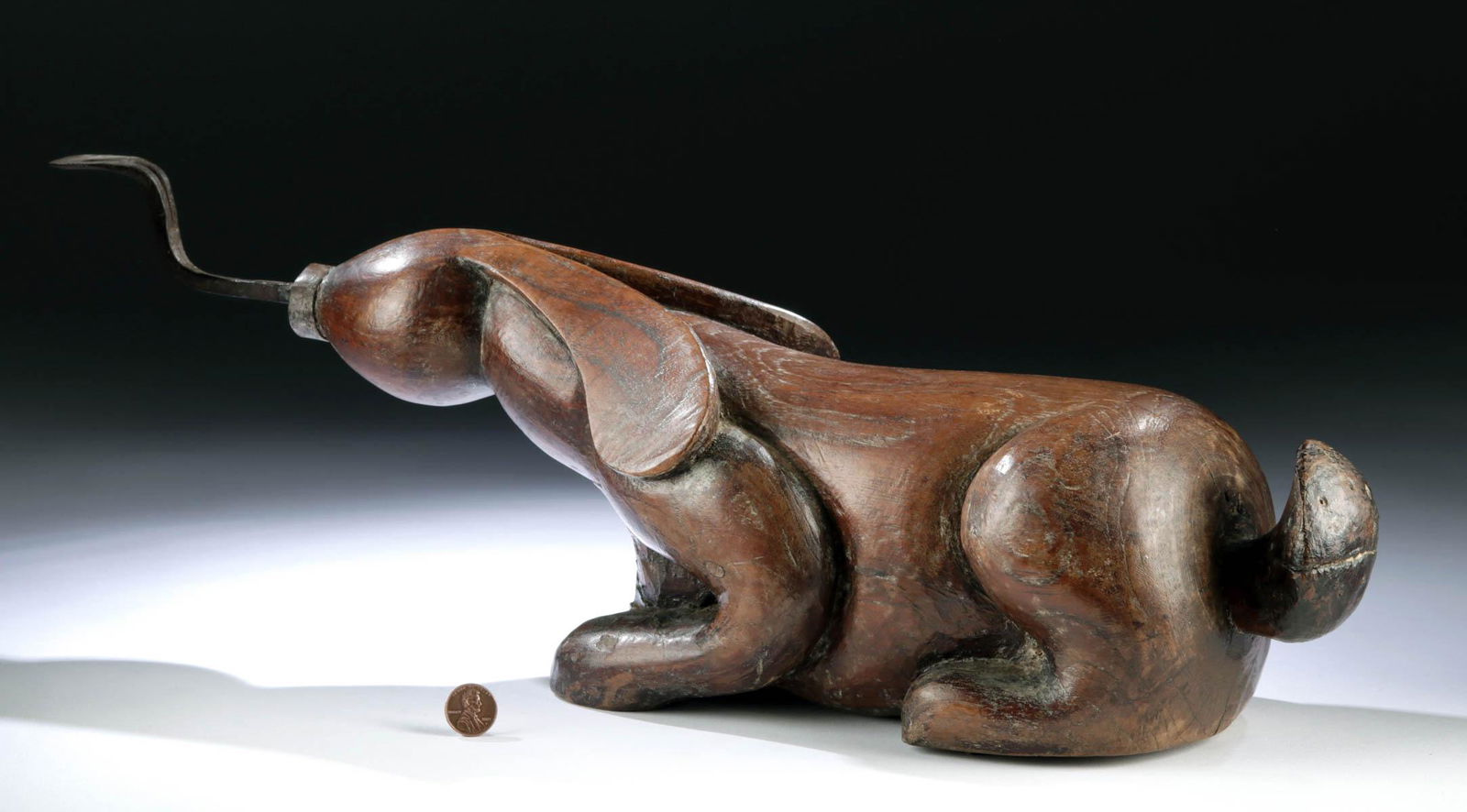 19th C. Thai Wood Coconut Grater - Rabbit Form: Southeast Asia, Thailand or Cambodia, ca. late 19th to early 20th century CE. A hand-carved wooden coconut grater depicting a highly-stylized rabbit. The lively bunny is poised upon his retracted legs