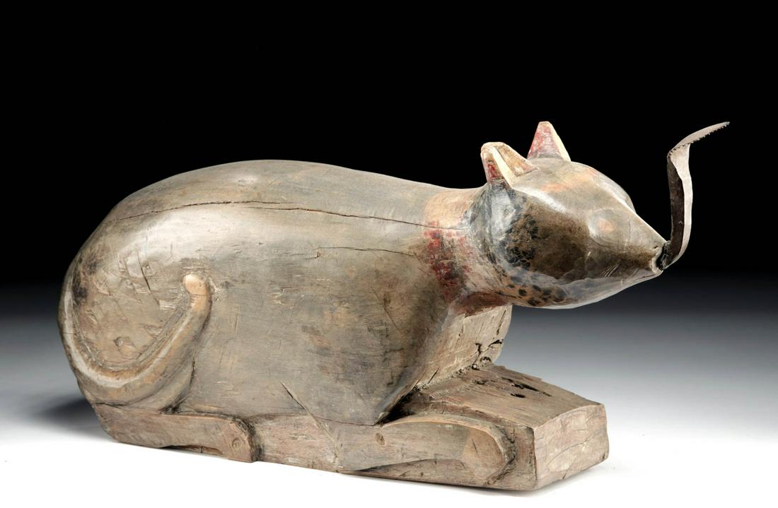 19th C. Thai Wood Coconut Grater - Recumbent Cat: Southeast Asia, Thailand or Cambodia, ca. late 19th to early 20th century CE. A hand-carved wooden coconut grater in the form of a recumbent feline with all four legs tucked beneath its body and a sin