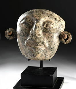 Stunning Maya Greenstone Mask w/ Earspools: Pre-Columbian, Mexico and northern Central America, Maya Territories, Late Classic, ca. 550 to 900 CE. A stunning mottled greenstone mask, made to be worn over the face of a king in his grave. Ear