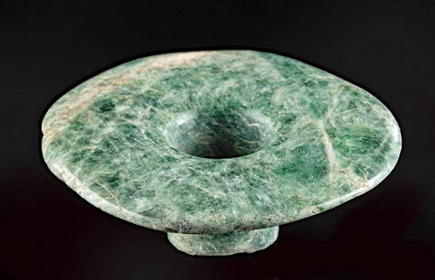 Maya Jadeite Ear Spool w/ Nice Coloration - Ex Harner: Pre-Columbian, Southern Mexico to Guatemala, Maya, Late Classic Period, ca. 550 to 900 CE. A beautiful ear spool of a relatively circular form that is hand-carved from mottled forest-green jadeite