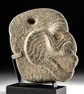 Superb Maya Granite Hacha Monkey Head: Pre-Columbian, Maya territories, ca. 500 to 800 CE. A mottled granite hacha associated with the Meso-American ballgame, finely carved in the form of a monkey head in profile with a wide open, circular