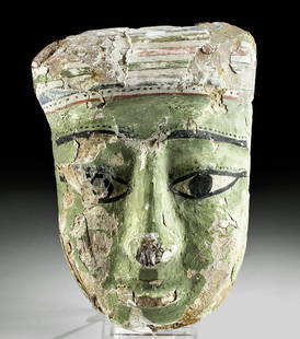 Egyptian Painted Gesso / Cedar Sarcophagus Mask: Egypt, Late Dynastic to Ptolemaic Period, ca. 664 to 30 BCE. A hand-carved cedar wood mask with large almond-shaped eyes beneath slender brows, a wide nose, rounded cheeks, and full lips, all beneath