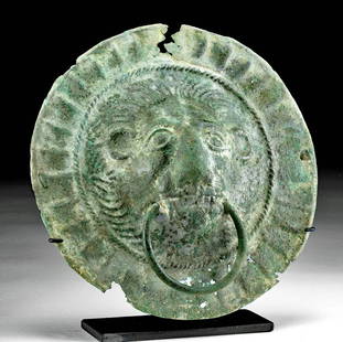Rare Etruscan Bronze Boss Lion w/ Ring in Mouth: Northern Italy, Etruscan, ca. 6th to 5th century BCE. Finely cast via the lost wax (cire perdue) technique, a leaded bronze boss adorned with a leonine visage in repousse with a ring in its mouth.