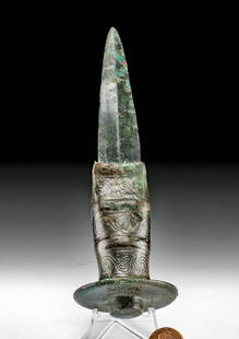 Rare European Bronze Full Handled Dagger: Central Europe, Bronze Age, ca. late 2nd to early 1st millennium BCE. A cast bronze dagger with a heavy, rounded handle. The surface of the handle is decorated with a low relief design of interlocked