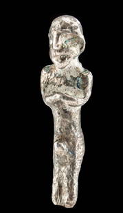 Syro-Hittite Silver Anthropomorphic Amulet: Ancient Near East, Syro-Hittite, ca. 2nd millennium BCE. A charming 81.6% silver amulet of an anthropomorphic figure with simple features. His legs are fused together, and a protruding knob indicates