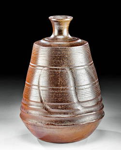 17th C. Japanese Edo Bizen Ware Sake Bottle: East Asia, Japan, Bizen Province, early Edo period, ca. late 17th century CE. A remarkable pottery sake bottle displaying an annular, flared rim, a narrow, tubular neck, a tiered shoulder, and a broad