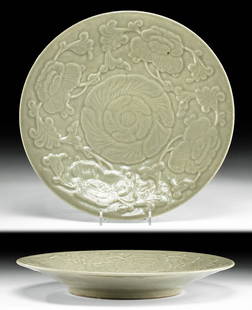 19th C. Chinese Qing Celadon Glazed Plate Relief: East Asia, China, Qing Dynasty, ca. late 19th century CE. A stunning stoneware plate enveloped in a lovely celadon glaze and presenting a discoid foot and slanted walls that rise to a circular rim