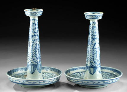 19th C. Chinese Qing Porcelain Candle Holders (pr): East Asia, China, Qing Dynasty, ca. 19th century CE. A lovely pair of porcelain candle holders featuring floral and geometric motifs. Both are shaped with a large drip pan basin comprised of a cavity