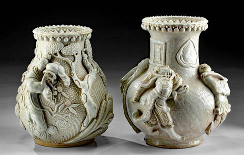 19th C. Chinese Qing Blanc De Chine Vases (pr): East Asia, China, Qing Dynasty, ca. 19th century CE. A wonderful pair of porcelain vessels in a style known as Blanc de Chine with sculpted reliefs on the sides. The first is comprised of a ring foot