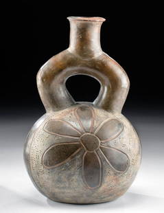 Chavin Pottery Stirrup Vessel with Flower: Pre-Columbian, North Coast Peru, Chavin, North Coast Peru, Casa Grande, ca. 1200 to 1000 BCE. A charming example of a hand-built greyware stirrup vessel, the elegant form presenting with a voluminous