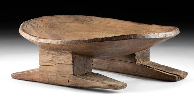 Important Nazca Wood Bench / Tiana: Pre-Columbian, South Coast Peru, Nazca, ca. 200 to 600 CE. A rare and remarkable wooden bench, known as a tiana, displaying a circular, concave seat supported by two thick legs with a pair of