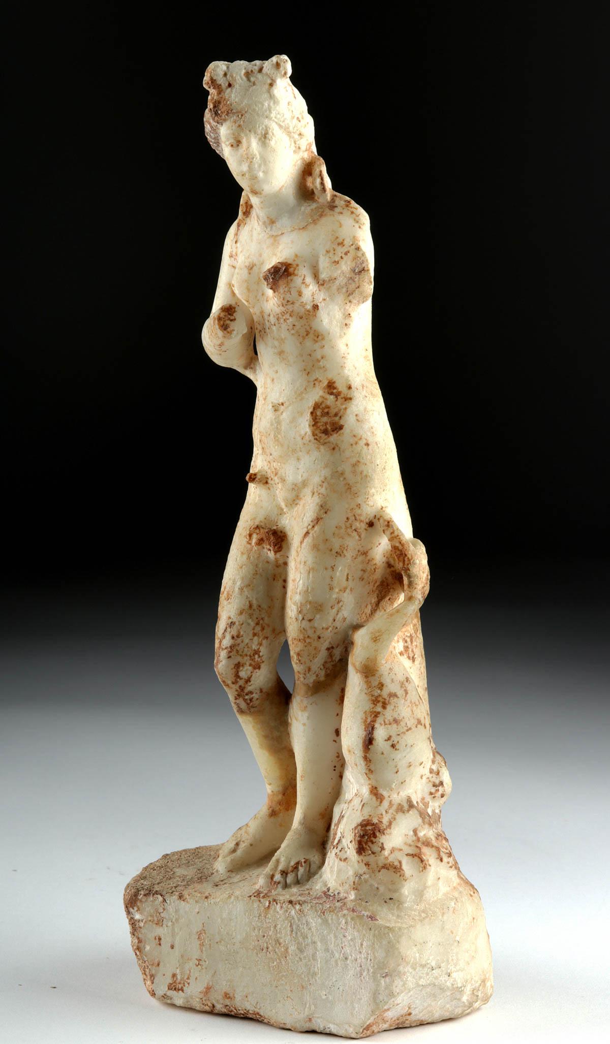Greek Marble Statue of Aphrodite w/ Dolphin: Magna Graecia, ca. 300 BCE, found in Sicily. Finely carved in the round, a marble statue of Aphrodite (Roman Venus), the goddess of love born from the sea, with a dolphin by her side symbolizing her b