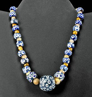 Wearable Ancient Carthage Glass Eye Bead Necklace: North Africa, Carthage, ca. 4th to 2nd century BCE. A beautiful necklace comprised of over 50 ancient glass beads. The beads are symmetrically strung on a modern wire with alternating eye beads and