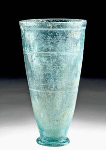 Roman / Frankish Wheel-Cut Glass Beaker: Western Europe, Roman or Frankish people, ca. 1st to 3rd century CE. A beautiful and large wheel-cut glass beaker, with a pale aqua hue. The vessel tapers gracefully upward from a small foot and