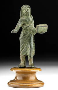 Published Roman Leaded Bronze Priest - ex Sotheby's: Roman, Imperial Period, ca. 2nd to 3rd century CE. Expertly cast via the lost wax (cire perdue) method, a leaded bronze figure of an elderly priest, standing with his left leg slightly advanced,