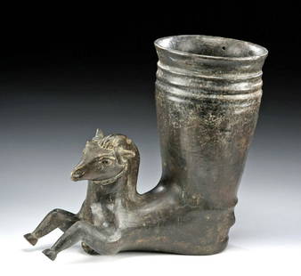 Published Parthian Blackware Rhyton w/ Horse Handle: Near East, Parthia, ca. 3rd to 1st century BCE. A sizeable and very finely rendered blackware pottery rhyton featuring the forepart of a horse at the front of an otherwise cylindrical vessel that