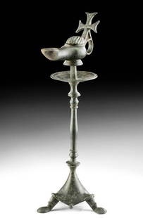 Fine Byzantine Bronze Lamp on Stand, ex-Royal Athena: Near East / Holy Land, Byzantium, ca. 5th to 7th century CE. A finely cast bronze oil lamp on a stand, the lamp decorated with an integrally cast Cross atop the handle, the stand a tripodal pricket
