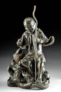 18th C. Chinese Qing Lead Seated Male, Basket of Fish: East Asia, China, Qing Dynasty, ca. late 18th to early 19th century CE. A charming hollow lead statue of an intricately detailed seated man next to a basket of fish expertly cast via the lost wax