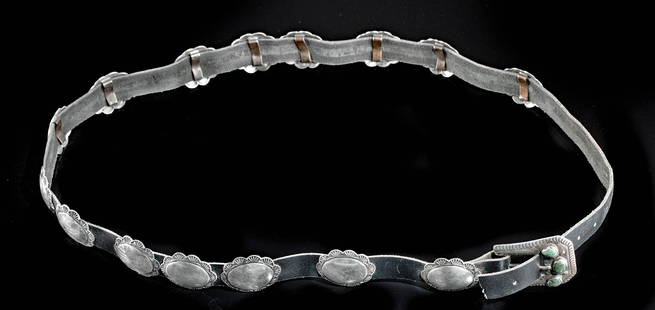 Vintage Navajo Silver, Turquoise & Leather Concha Belt: Native American, Southwest United States, Navajo, ca. 1930s CE. A stylish silver concha belt with a leather band and a pretty buckle with three turquoise stones. Along the length are fifteen 93.15%