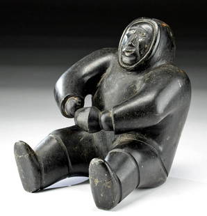 20th C. Native American Inuit Soapstone Seated Figure: First Nations / Native American, Canadian Arctic, Inuit, ca. 1950s to 1960s CE. An excellent, carved soapstone figure of a seated figure with both legs stretched out in front of him, slightly raised