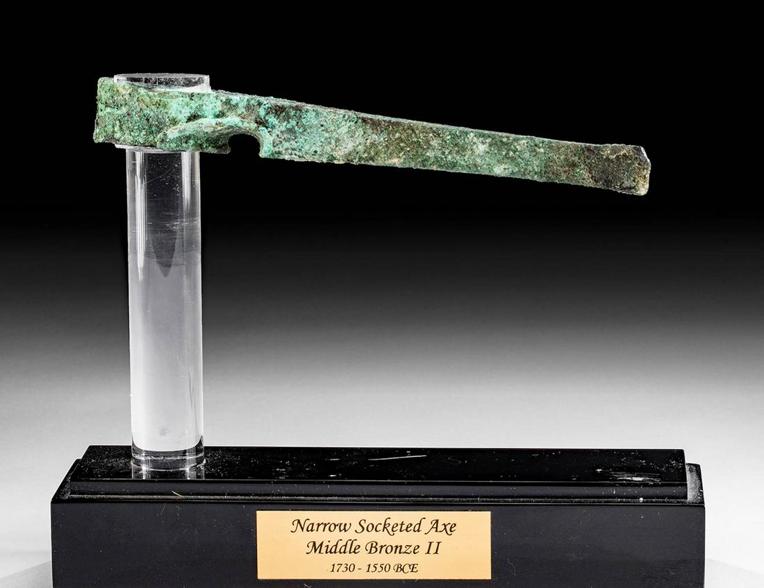 Slender Canaanite Leaded-Bronze Axe Head: **First Time At Auction** Ancient Near East, Canaan, the Levant, Middle Bronze Age II, ca. 1730 to 1550 BCE. A fabulous leaded-bronze axe head of a very slender design and rich green patina. The blade