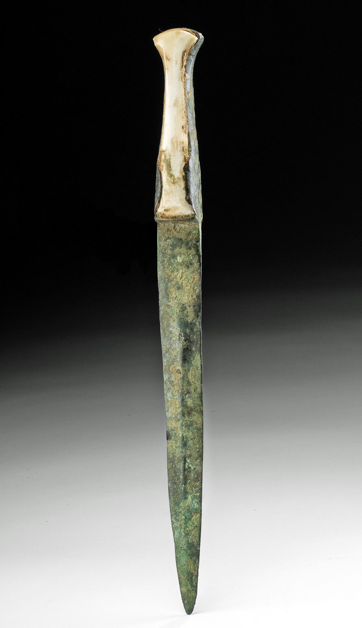 Luristan Copper Dagger with Bone Handle: Ancient Near East, northwestern Iran, Luristan, ca. 1000 to 600 BCE. A cast-copper dagger with a slender tang and an elongated triangular blade with a shallow midrib, sharpened edges, and a pointed ti